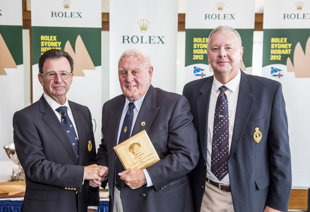 Rowan Johnson receives his Meritorious Service Award from CYCA Commodore Howard Piggott and RYCT Commodore Graham Taplin